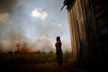 Incêndios na Amazônia: Moradora olha enquanto fogo se aproxima de sua casa perto de Porto Velho, no dia 16 de agosto (Foto: Ueslei Marcelino/Reuters)